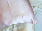 Personalized embroidery detail on pink silk pillowcase