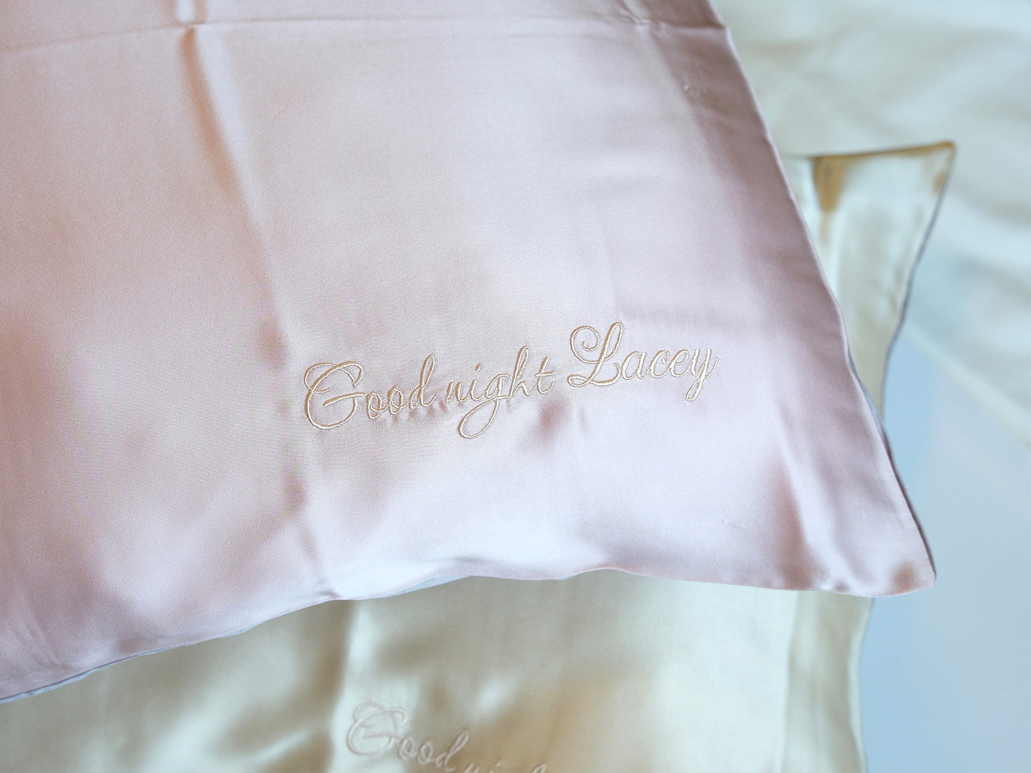 Personalized embroidery detail on pink silk pillowcase