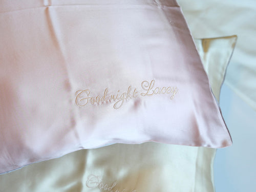 Personalized embroidery detail on pink silk pillowcase
