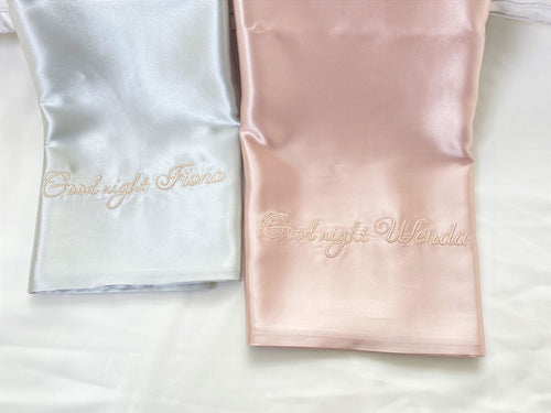 Personalized 22 momme double sided silk pillowcase in pink and silver with custom embroidered names