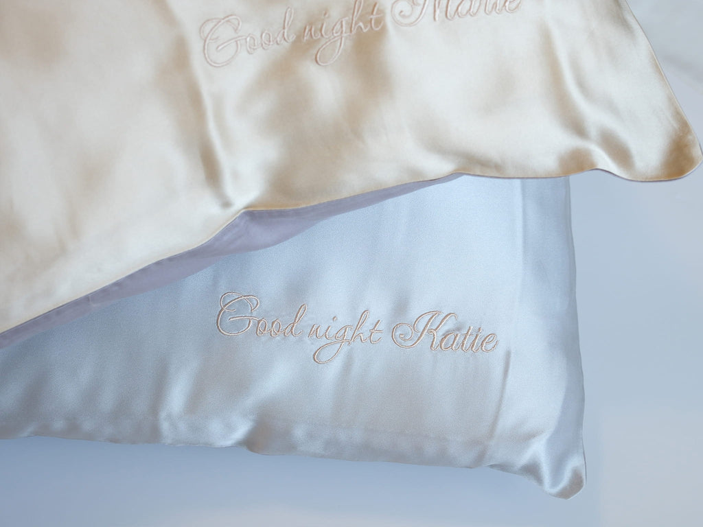 Personalized embroidery detail on gray silk pillowcase