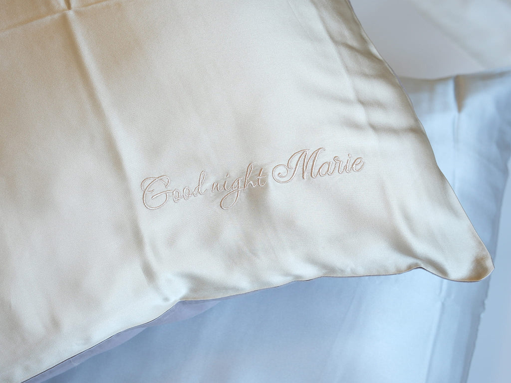 Personalized embroidery detail on gold silk pillowcase