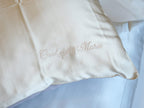 Personalized embroidery detail on gold silk pillowcase