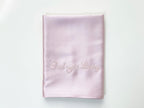 Folded pink silk pillowcase with personalized embroidery