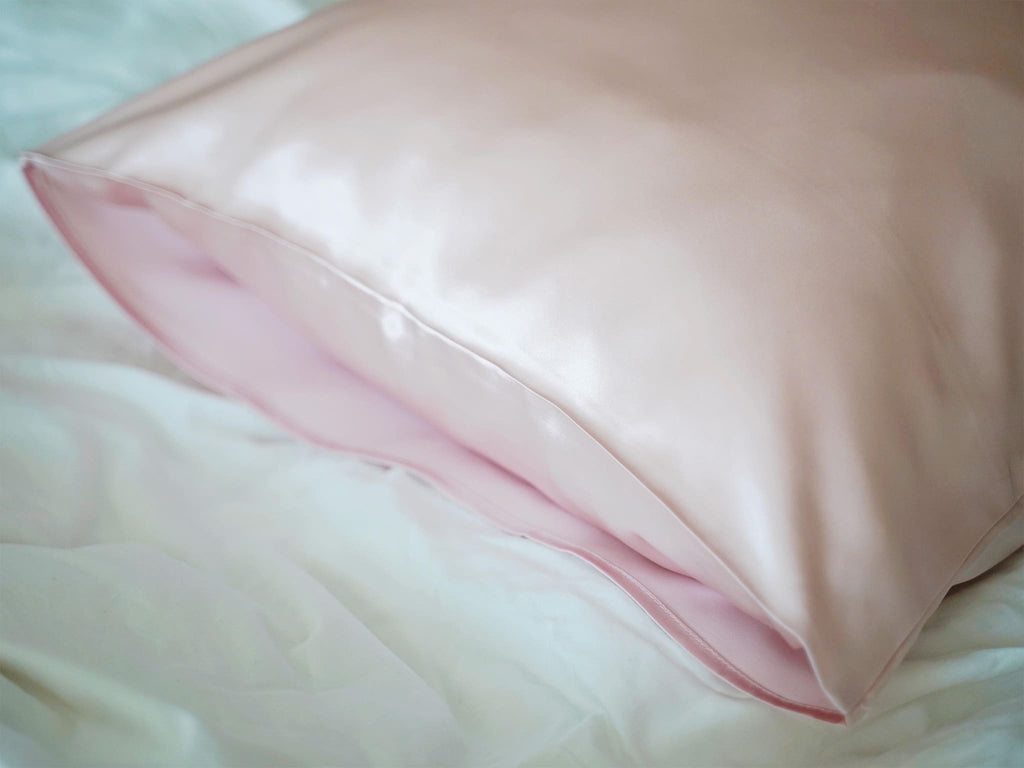 Close-up of pink 22 momme double sided mulberry silk pillowcase on bed