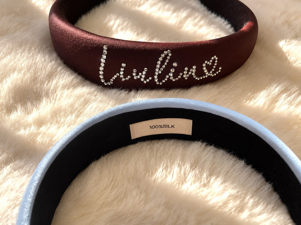 Inner view of personalized silk padded headband showing 100% silk label on a soft plush background.