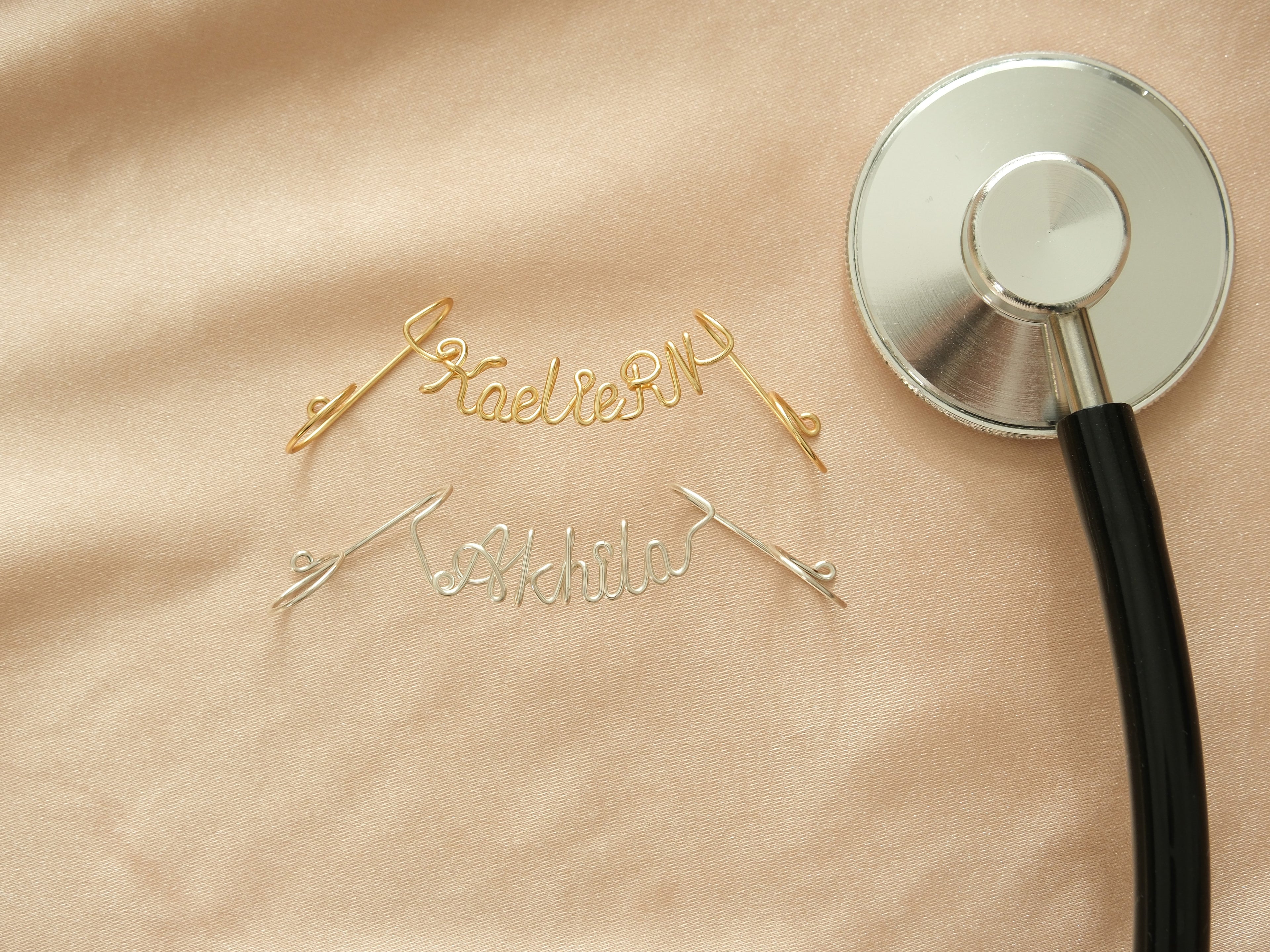Gold and silver stethoscope name tags with an adjustable design.