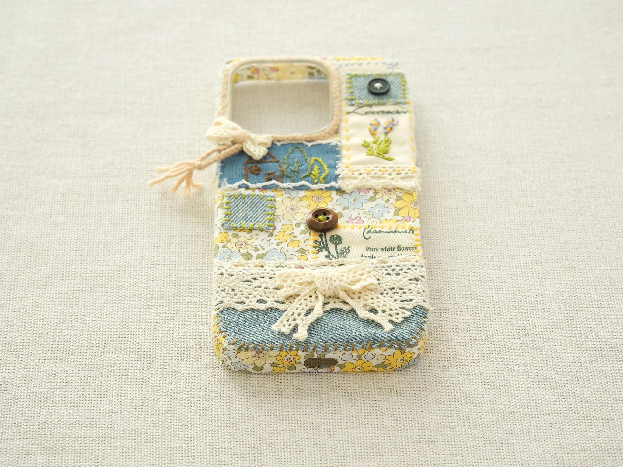 Bottom view of the patchwork case with precise cutouts for the charging port and speakers.