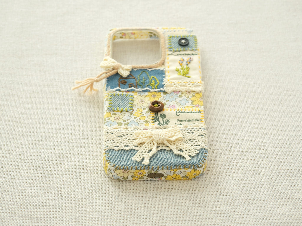 Bottom view of the patchwork case with precise cutouts for the charging port and speakers.