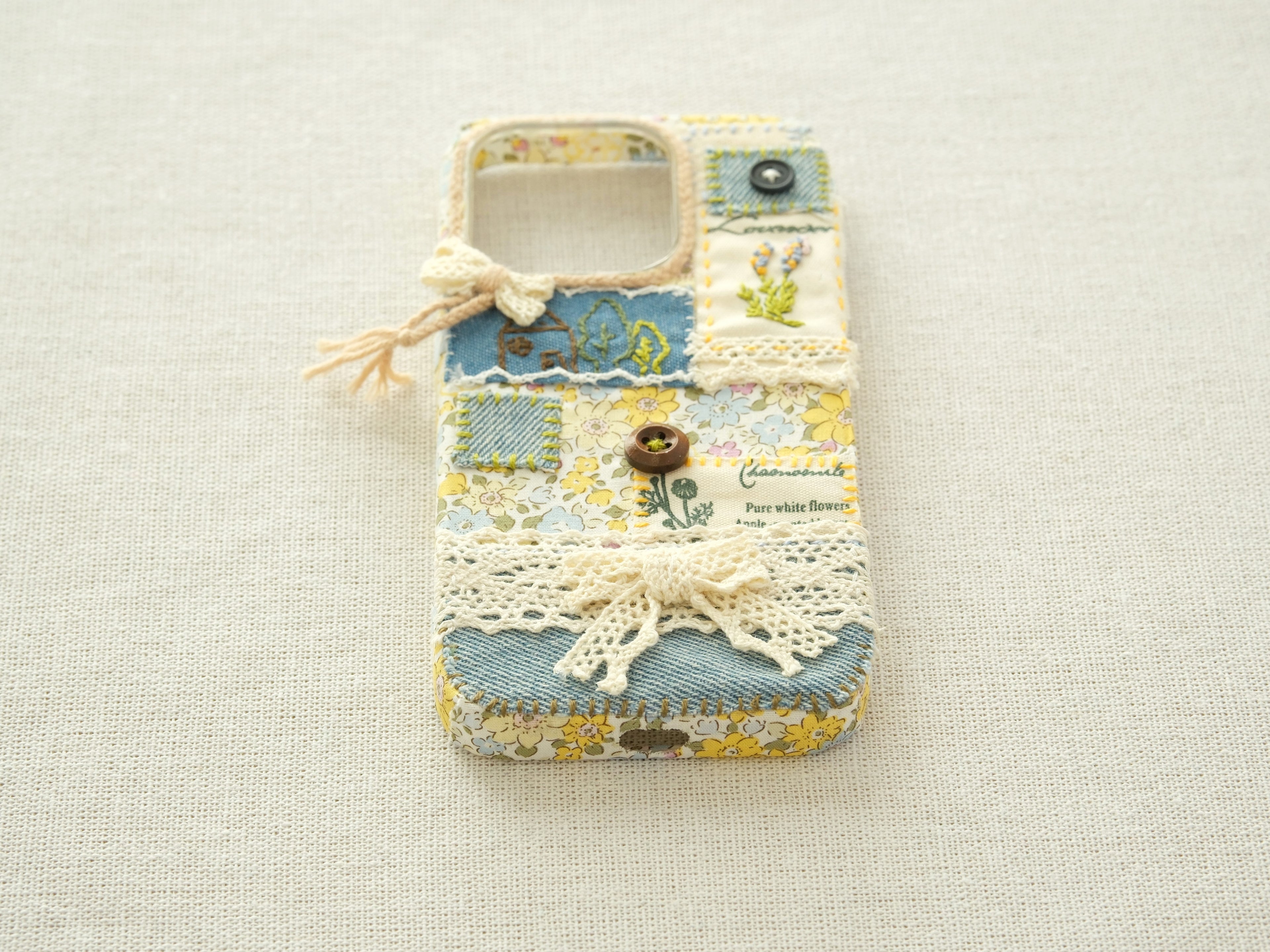 Bottom view of the patchwork case with precise cutouts for the charging port and speakers.