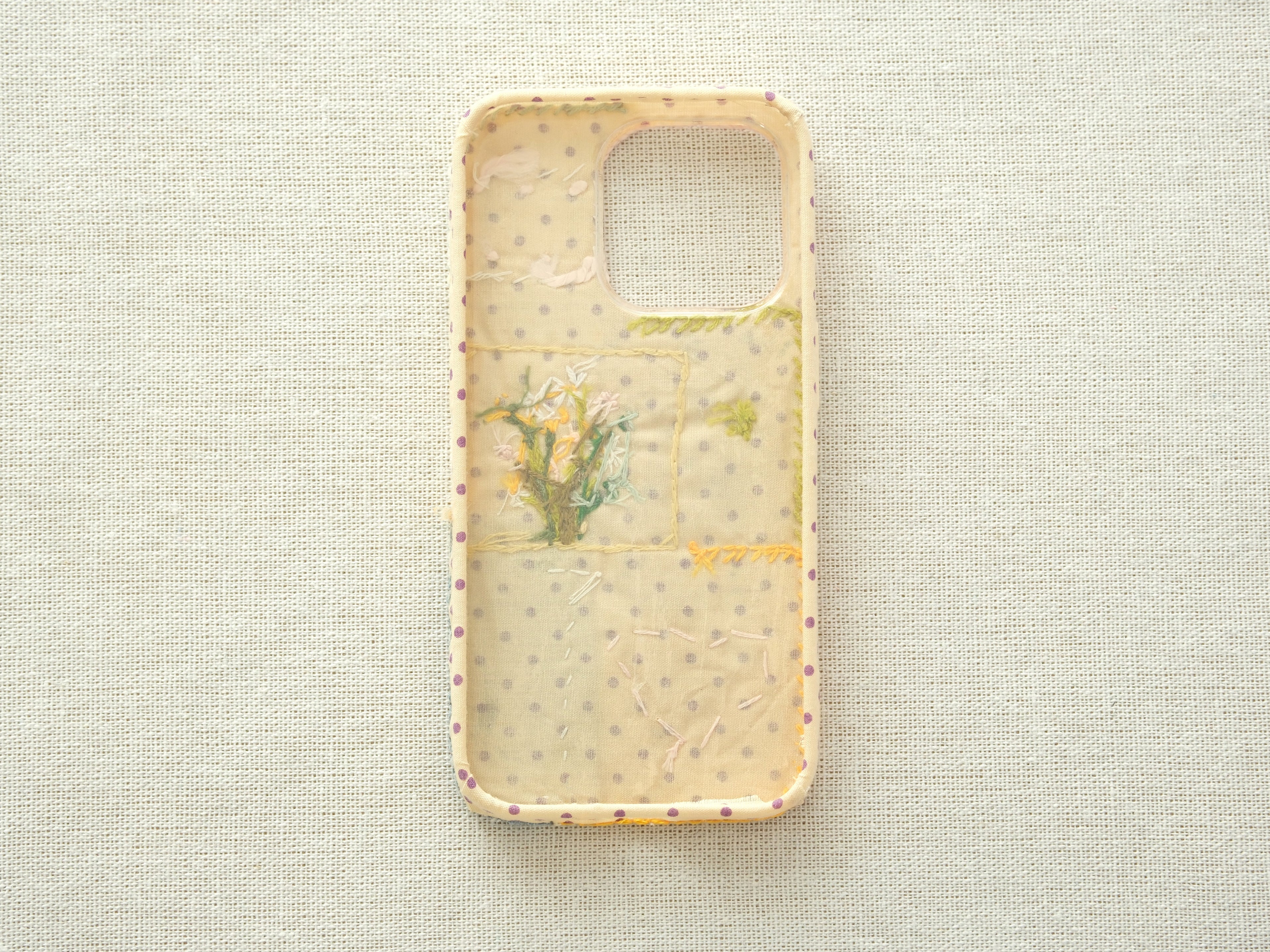 Interior view of the "Floral Heart" case showing a purple polka dot lining and handcrafted stitching details.