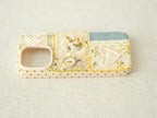 Side view of the patchwork case featuring purple polka dots and precise volume button access, artisanal style.