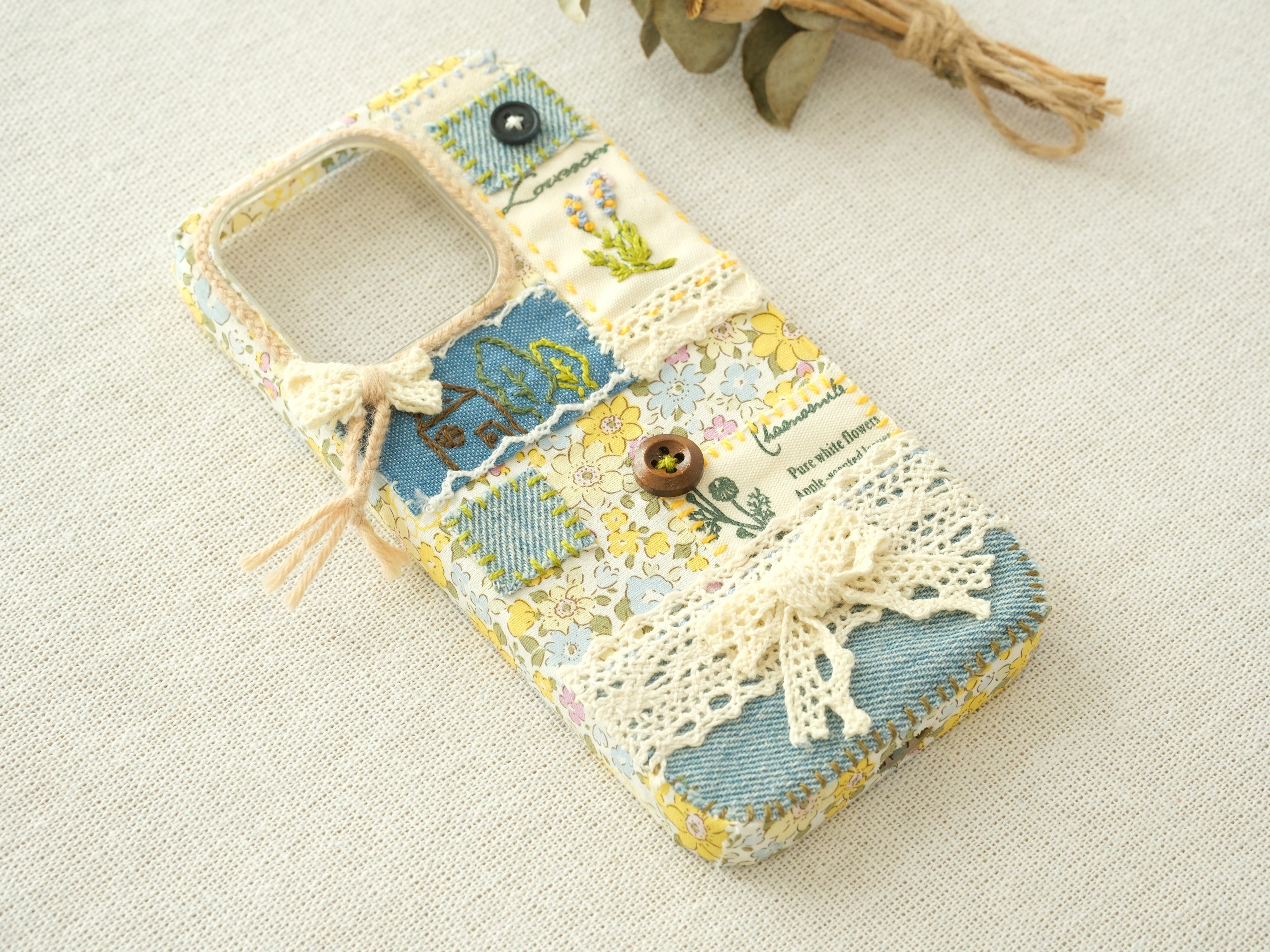 Side view of the patchwork case featuring layered lace and embossed embroidery, unique handcrafted design.