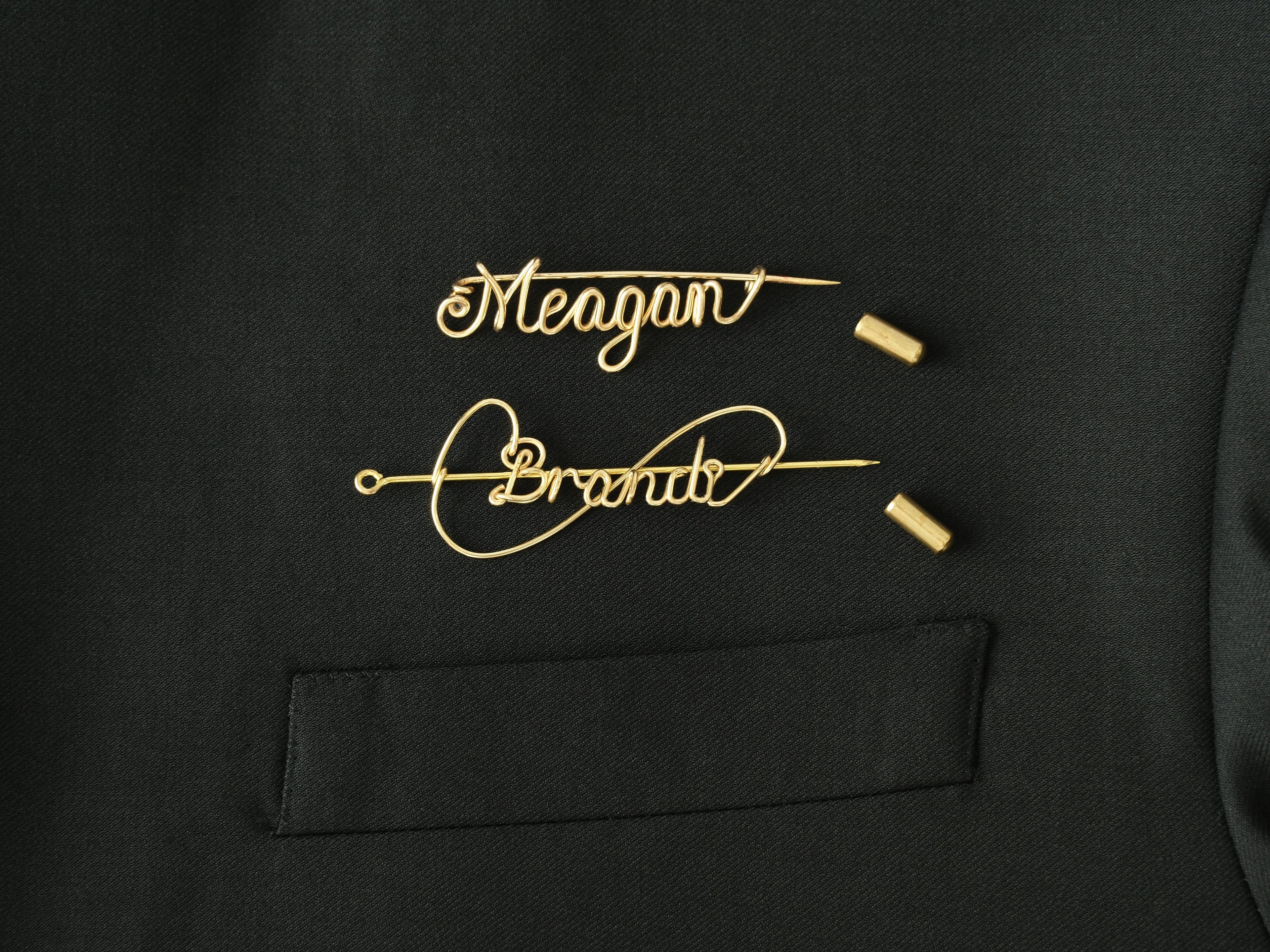Detailed view of the protective cap closure on a custom gold name brooch.