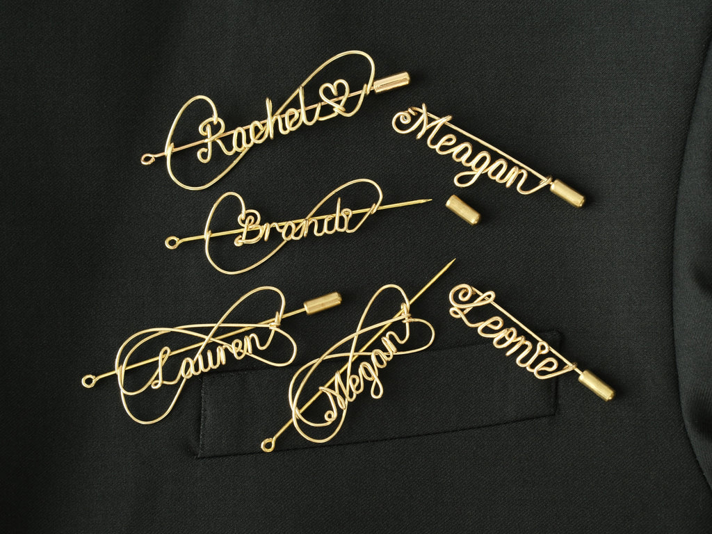 Collection of various custom name brooches in different artisanal styles and bespoke names.