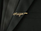 Custom name brooch in minimalist style, handmade in gold-plated copper wire on a jacket lapel.