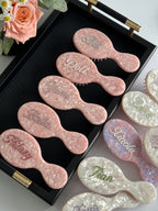 Personalized pink marble mini brushes with glittering rhinestone names, a perfect romantic gift or for friends.