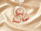 Three personalized red metal wine glass charms with names, elegant decoration for wine glasses and wedding tables.