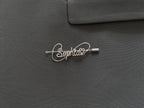 Personalized silver-plated name pin with a heart symbol on a dark green jacket, perfect gift idea.