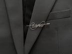 Modern infinite-line design personalized name pin, crafted in silver-plated finish on a dark green jacket.
