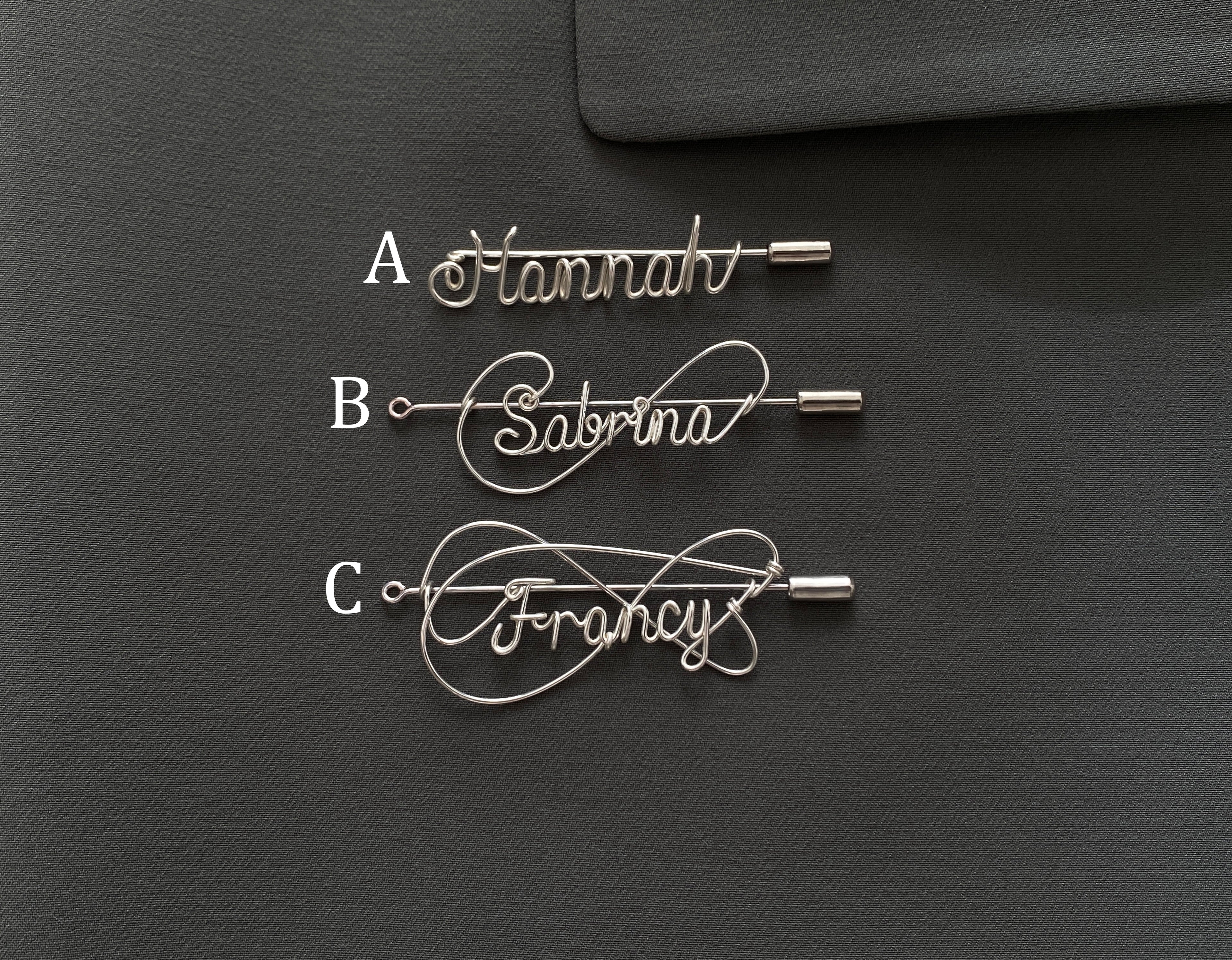 Comparison of three silver personalized name pin styles (A, B, C) on a dark green jacket, selection guide.