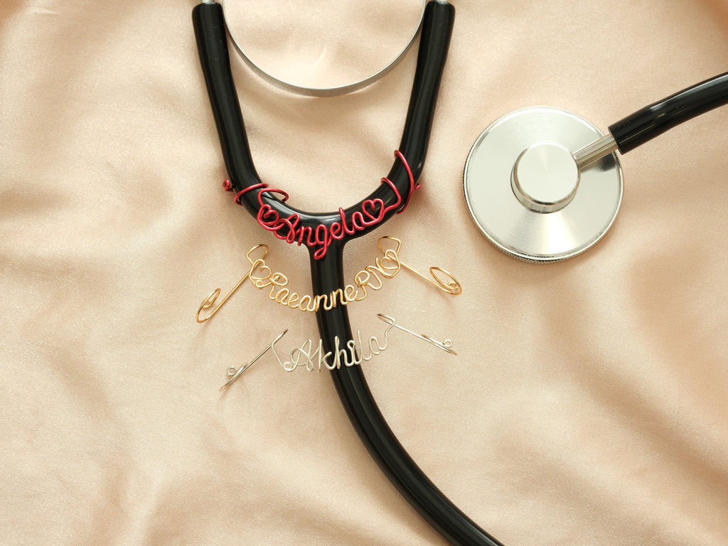 Three personalized stethoscope name tags in red, gold, and silver metal—an ideal gift for doctors and nurses.