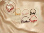 Overview of all available colors for personalized wine glass charms, including gold, silver, pink, and purple.