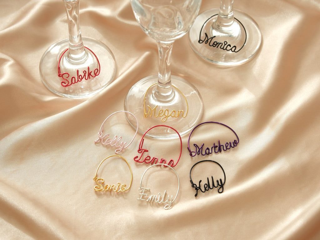 Collection of personalized wine glass charms in various colors, ideal for weddings and private parties.